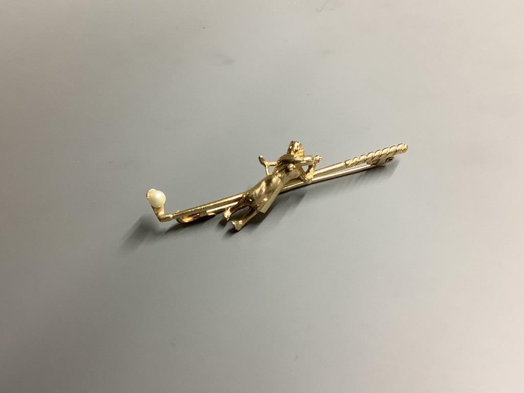 A modern 9ct gold and seed pearl set bar brooch, modelled as a golfer and golf club, 56mm, gross 4.8 grams.